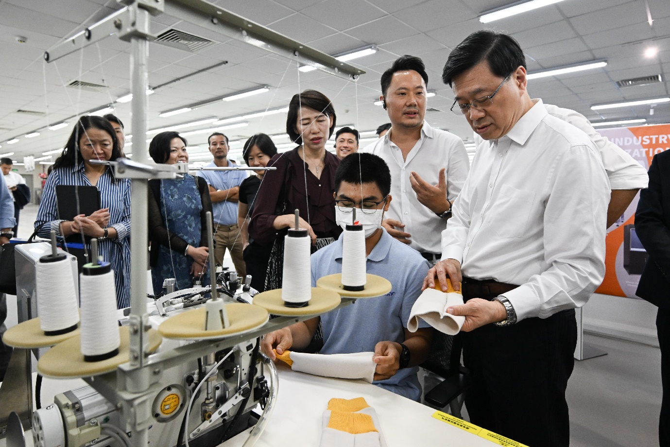 Mr Lee (first right) visits a garment manufacturer in Vietnam headquartered in Hong Kong.